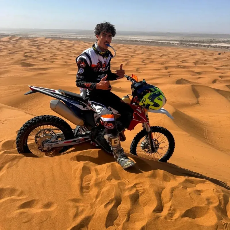 Mohamed, local enduro guide from Merzouga, with his motorcycle in the Erg Chebbi dunes